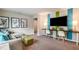 Cozy living room with playful decor, comfortable seating, and a large entertainment unit at 37213 Sagemoor Dr, Zephyrhills, FL 33541