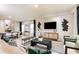Open-concept living and dining area with modern decor, built in entertainment center and plenty of natural light at 37213 Sagemoor Dr, Zephyrhills, FL 33541