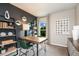 Home office featuring a dark accent wall, modern furniture, and natural light from the window at 37213 Sagemoor Dr, Zephyrhills, FL 33541