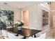 Bright dining room featuring contemporary decor, light wood floors, and a stylish black dining table set for six at 37230 Sagemoor Dr, Zephyrhills, FL 33541