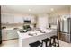 Modern kitchen with gray cabinets, stainless steel appliances, and an island with seating at 37230 Sagemoor Dr, Zephyrhills, FL 33541