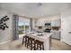 Kitchen with an island, stainless steel appliances, gray cabinetry and sliding glass door to the exterior at 37244 Sagemoor Dr, Zephyrhills, FL 33541