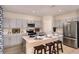 Modern kitchen with an island, stainless steel appliances, gray cabinetry, and an open layout at 37244 Sagemoor Dr, Zephyrhills, FL 33541