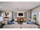 Comfortable living room with sofas, a TV, and decorative curtains, creating a relaxing space at 37244 Sagemoor Dr, Zephyrhills, FL 33541