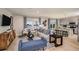 Open-concept living room with stylish decor, including a comfortable sofa, an area rug, and a view of the lake at 37244 Sagemoor Dr, Zephyrhills, FL 33541