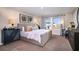 Spacious main bedroom with a comfortable bed, stylish decor, and bright windows at 37244 Sagemoor Dr, Zephyrhills, FL 33541