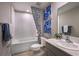 Modern bathroom with a tub/shower combo, elegant vanity, and stylish blue accents at 37252 Sagemoor Dr, Zephyrhills, FL 33541