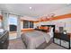Themed bedroom with bold orange accents, basketball decor, and ample natural light, creating a fun and vibrant space at 37252 Sagemoor Dr, Zephyrhills, FL 33541