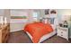 Cozy bedroom features a queen bed, vibrant decor, and a bright window view at 37252 Sagemoor Dr, Zephyrhills, FL 33541
