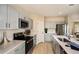 Clean kitchen with stainless steel appliances, modern gray cabinetry, and quartz countertops at 37252 Sagemoor Dr, Zephyrhills, FL 33541