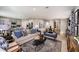 Open-concept living room with modern decor and a view into the kitchen at 37252 Sagemoor Dr, Zephyrhills, FL 33541