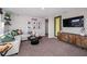 Inviting living room featuring a comfortable seating area, modern decor, and a mounted TV for cozy relaxation and entertainment at 37252 Sagemoor Dr, Zephyrhills, FL 33541