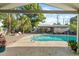 Beautiful backyard pool with a seating area, shed, and palm trees at 3961 15Th N Ave, St Petersburg, FL 33713