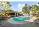 Inviting backyard pool with brick pavers, mature trees, and seating area at 3961 15Th N Ave, St Petersburg, FL 33713