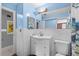 Clean bathroom featuring blue walls, white tiles, and a modern vanity at 3961 15Th N Ave, St Petersburg, FL 33713