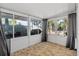 Enclosed Florida room with tile floor and multiple windows offering natural light and outdoor views at 3961 15Th N Ave, St Petersburg, FL 33713