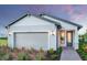 Charming single-Gathering home featuring a grey garage door and beautiful landscaping at 4650 Blue Star Ct, North Port, FL 34289