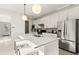 Clean and modern kitchen with island seating, stainless steel appliances, and white cabinetry at 4650 Blue Star Ct, North Port, FL 34289