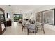 Open-concept living and dining area with modern lighting, neutral tones, and sliding glass doors to the backyard at 4650 Blue Star Ct, North Port, FL 34289