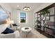 Bright living room featuring modern decor, including stylish chairs and a unique light fixture at 4650 Blue Star Ct, North Port, FL 34289