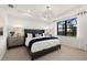 Serene main bedroom with a tray ceiling, a large window with a view, and modern decor at 4650 Blue Star Ct, North Port, FL 34289