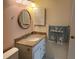 Traditional bathroom design featuring a granite countertop vanity, toilet and shell themed decor at 4814 Grist Mill Cir, New Port Richey, FL 34655