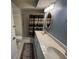 Bright bathroom features a double vanity with stone countertop and shower with neutral colored shower curtain at 4814 Grist Mill Cir, New Port Richey, FL 34655