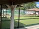 Outdoor bocce ball court with nearby tennis court and surrounding landscape at 4814 Grist Mill Cir, New Port Richey, FL 34655