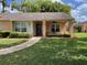 Charming single-story home with well-maintained landscaping, a covered entryway, and a welcoming front lawn at 4814 Grist Mill Cir, New Port Richey, FL 34655