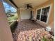 A front porch area with decorative tile, a ceiling fan, and an inviting seating arrangement at 4814 Grist Mill Cir, New Port Richey, FL 34655