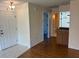 Open living space featuring tile flooring by the front door and a hallway leading to the bathroom at 4814 Grist Mill Cir, New Port Richey, FL 34655