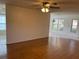 Open-concept living room with hardwood floors and a ceiling fan at 4814 Grist Mill Cir, New Port Richey, FL 34655