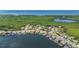 Aerial view showcases a community of beautiful waterfront homes nestled along a serene bay with lush greenery at 5104 E Longboat Blvd, Tampa, FL 33615
