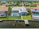 Backyard featuring a screened-in pool, boat lift, and dock for waterfront living at 5104 E Longboat Blvd, Tampa, FL 33615