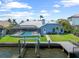 Backyard with pool, private dock, and lush green space, perfect for outdoor enjoyment at 5104 E Longboat Blvd, Tampa, FL 33615