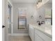 Bright bathroom features a large mirror, white cabinets, and black hardware at 5104 E Longboat Blvd, Tampa, FL 33615