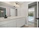 Bathroom view showcases cabinets, sink, mirror and view to the pool at 5104 E Longboat Blvd, Tampa, FL 33615