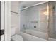 Tiled bathroom with glass shower doors over a tub and chrome hardware at 5104 E Longboat Blvd, Tampa, FL 33615