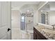 This bathroom showcases a walk-in shower with blue and white accents, a marble vanity and commode at 5104 E Longboat Blvd, Tampa, FL 33615