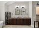 The bathroom features double vanity sinks with framed mirrors and a modern industrial style at 5104 E Longboat Blvd, Tampa, FL 33615