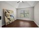 Bedroom featuring a tray ceiling, hardwood floors, neutral paint and one window with blinds at 5104 E Longboat Blvd, Tampa, FL 33615