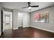 Bedroom with wood floor, ceiling fan, closet, and entry to hallway at 5104 E Longboat Blvd, Tampa, FL 33615