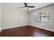 Bedroom with rich-toned wood floors and a window with natural light at 5104 E Longboat Blvd, Tampa, FL 33615