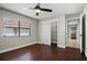 Bedroom with dark wood floor, ceiling fan, window, and closet space at 5104 E Longboat Blvd, Tampa, FL 33615