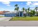 Two-story blue home boasting a meticulously maintained lawn, mature landscaping, and a welcoming facade at 5104 E Longboat Blvd, Tampa, FL 33615