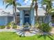 Beautiful home featuring a well-manicured lawn, a fountain, and a stately entrance at 5104 E Longboat Blvd, Tampa, FL 33615