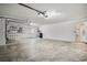 Spacious garage with shelving, water heater, door to the outside, and door to the main house at 5104 E Longboat Blvd, Tampa, FL 33615