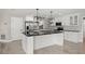 Beautiful kitchen features black granite countertops, stainless steel appliances, white cabinets, and tile flooring at 5104 E Longboat Blvd, Tampa, FL 33615