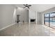 Spacious living room with fireplace, tile floors, and large sliding glass doors leading to pool area at 5104 E Longboat Blvd, Tampa, FL 33615