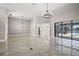 A spacious living room featuring views of the pool, stylish lighting, and a bright, open layout at 5104 E Longboat Blvd, Tampa, FL 33615